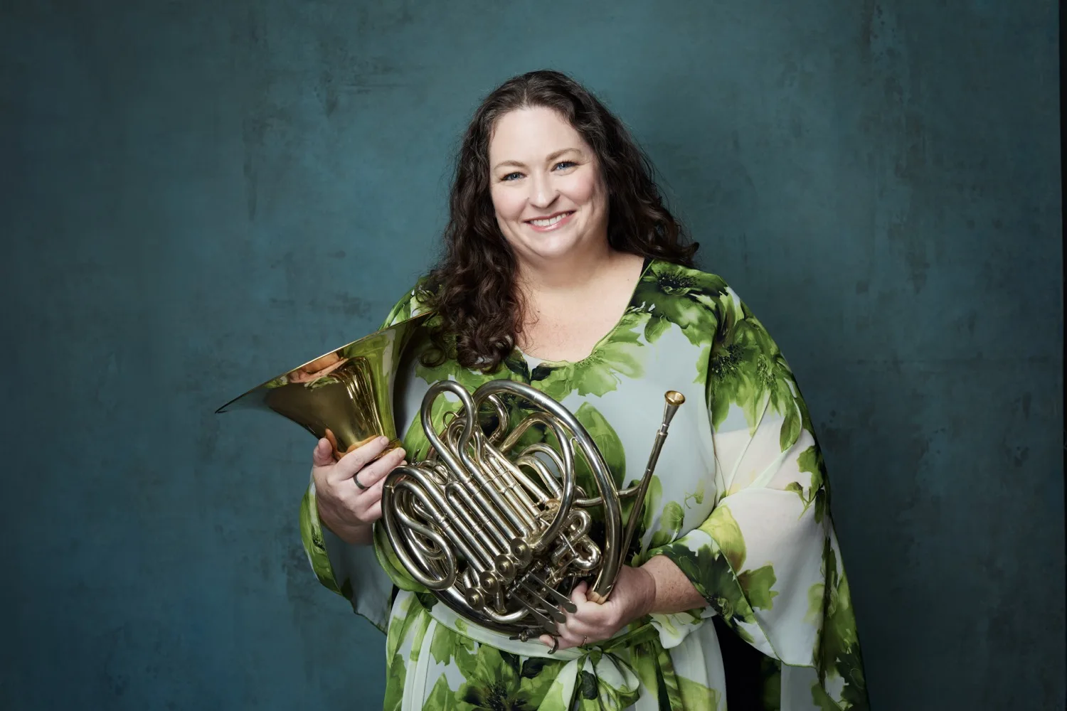 Half-body portrait of Megan Cullen against a green backdrop